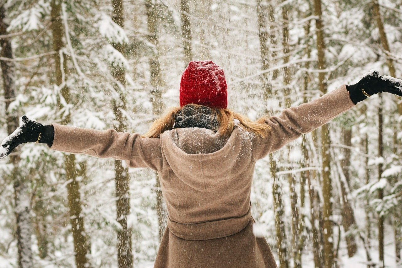 woman wearing a red hat in the snow