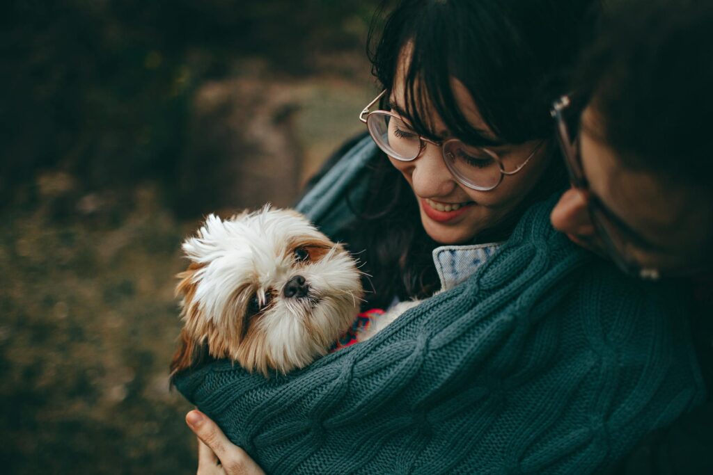A couple holding a dog